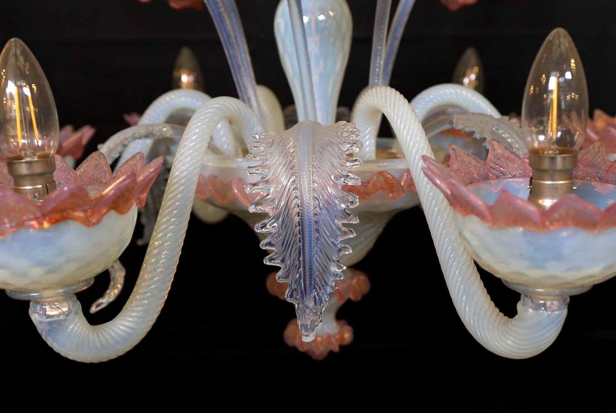 A 1950s Venetian pink and Vaseline glass six light chandelier with ornate flower and leaf motifs, height 90cm. width 70cm